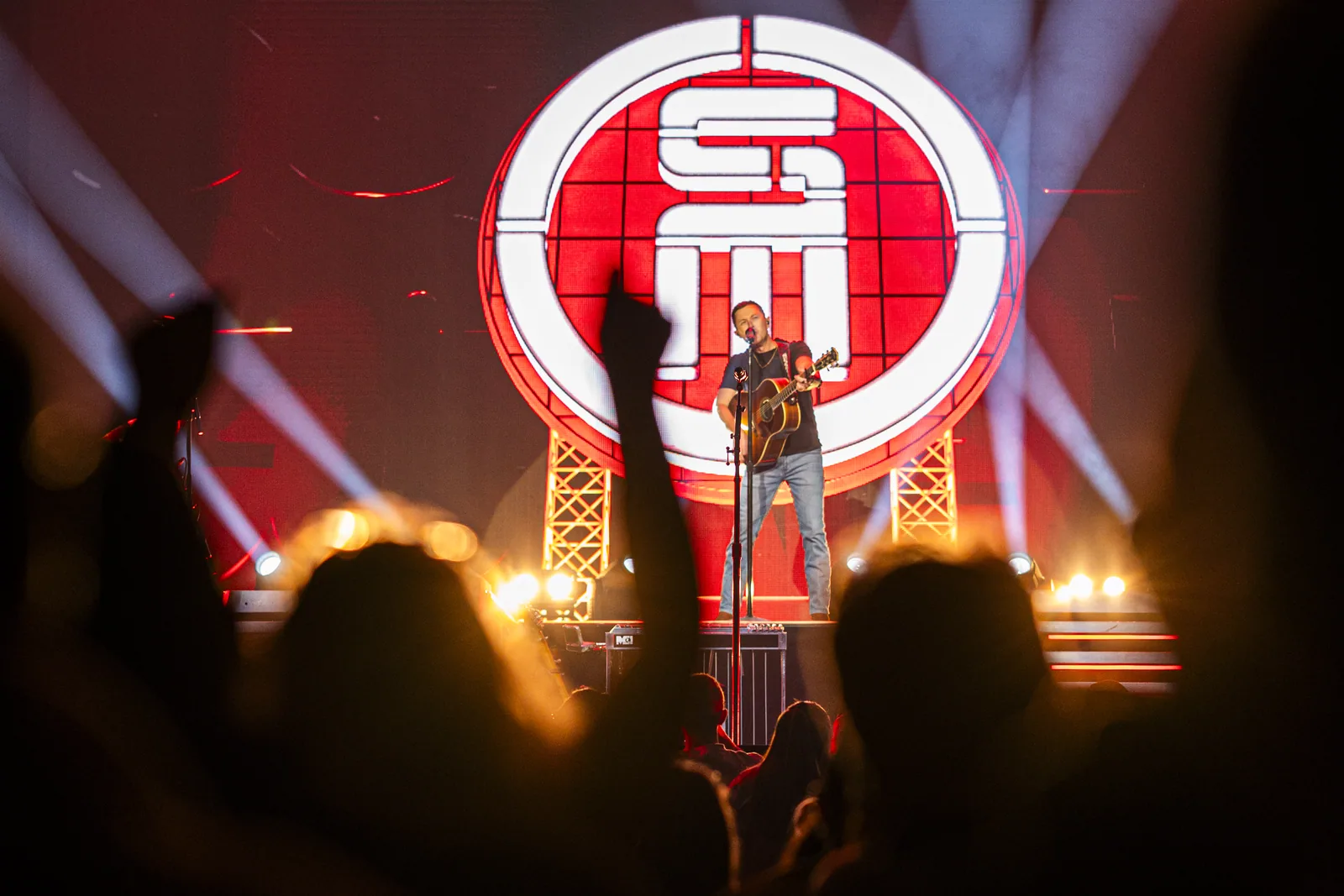 Scotty McCreery performs on stage at Casino Rama Resort, illuminated by bright stage lights